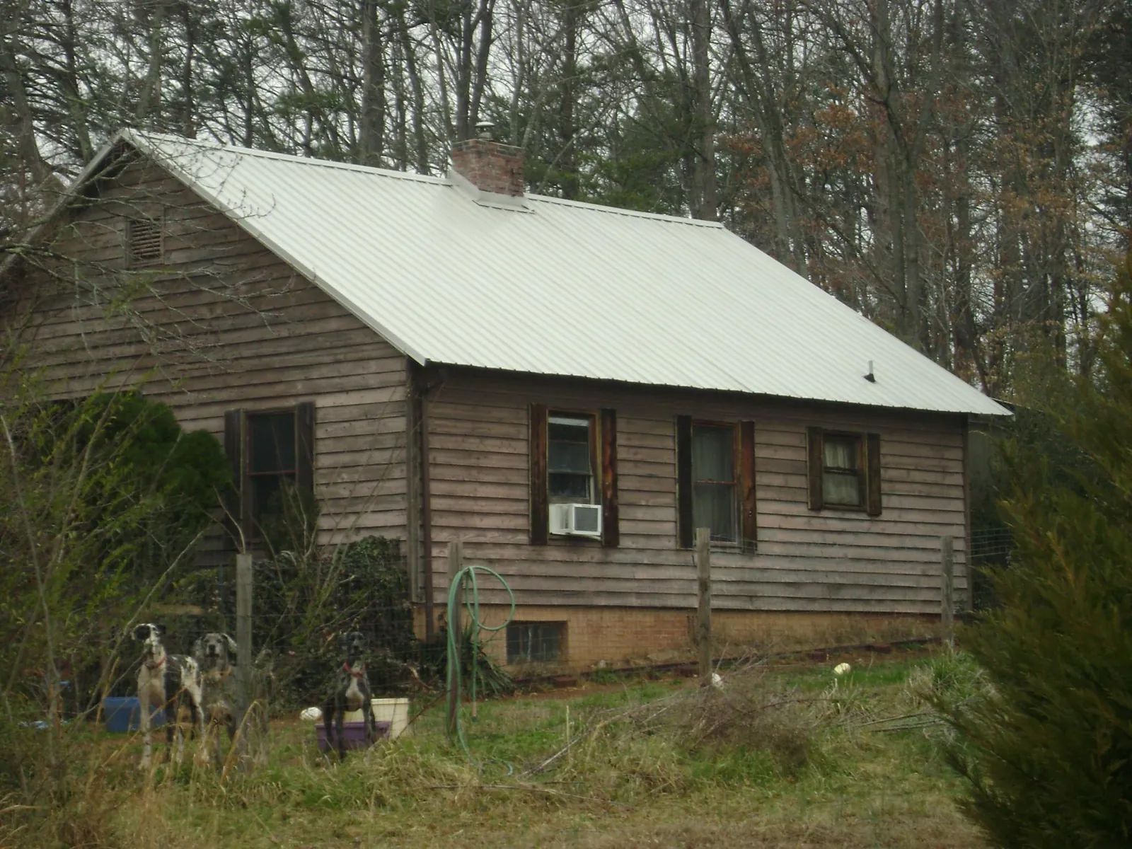 White metal roof on an old wood sided farmhouse, from a Metal Roof Installation job in Coventry